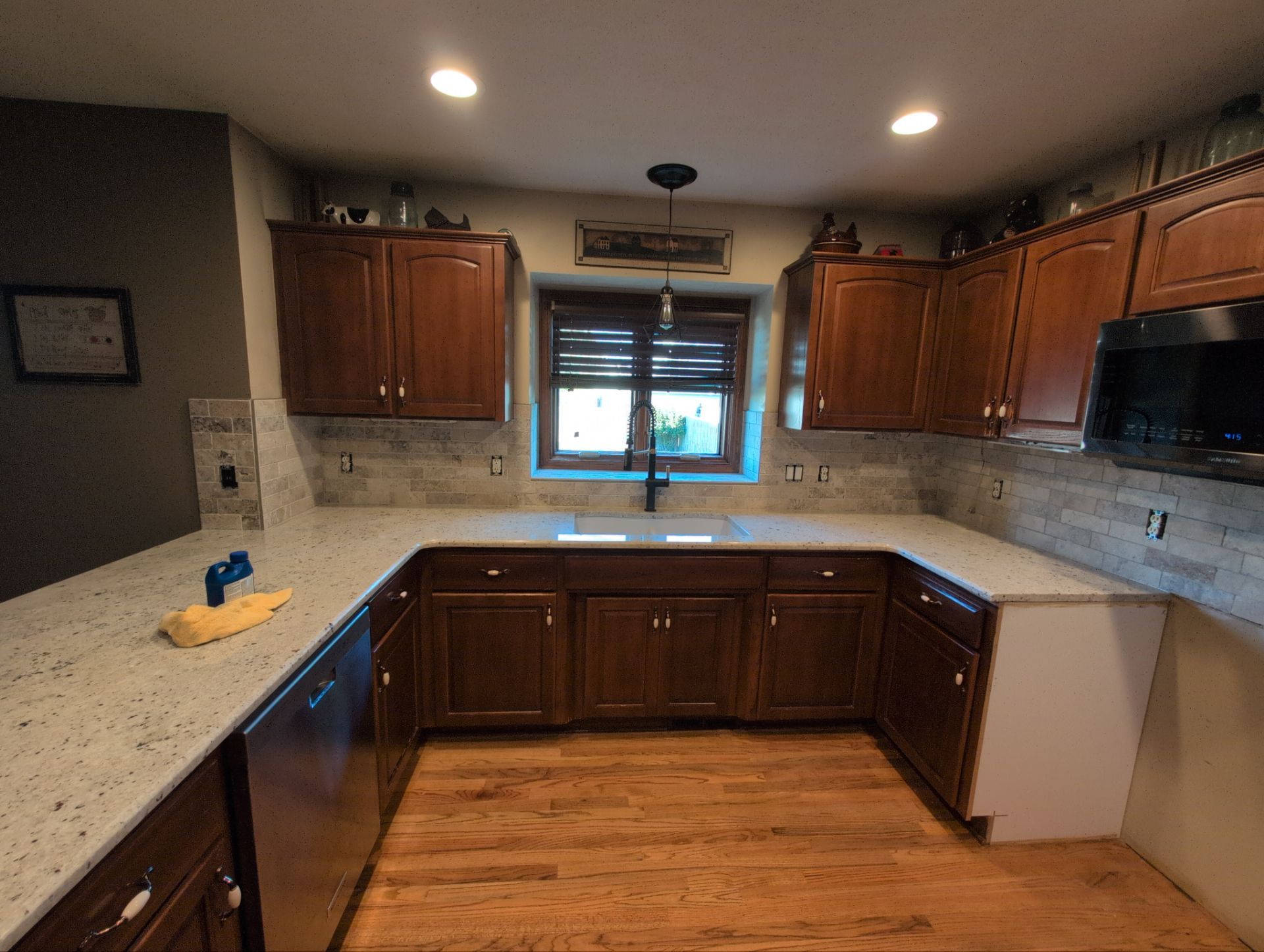 Natural stone travertine backsplash with cherry wood cabinets in Omaha kitchen